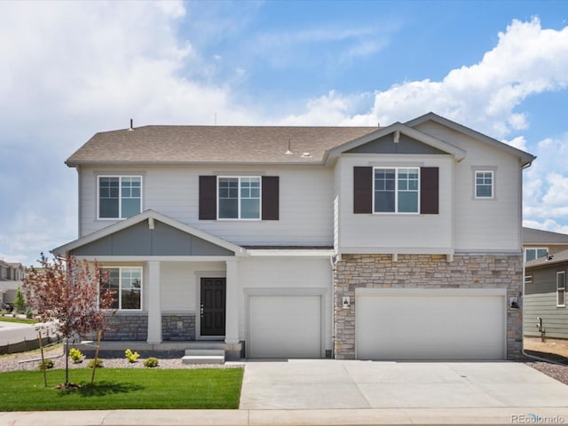 1612 Colorado River Dr, Windsor, CO 80550 - view of front of house with stone siding, a garage, concrete driveway, a front lawn, and a porch