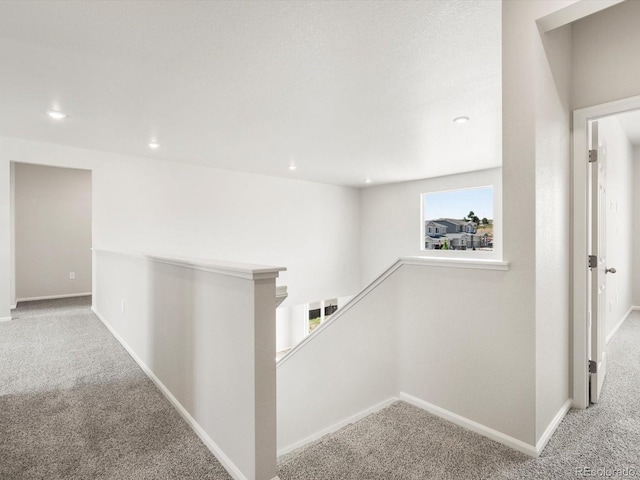 1612 Colorado River Dr, Windsor, CO 80550 - hall featuring an upstairs landing, carpet, and recessed lighting