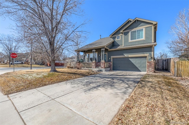 craftsman-style home featuring an attached garage, covered porch, brick siding, fence, and driveway