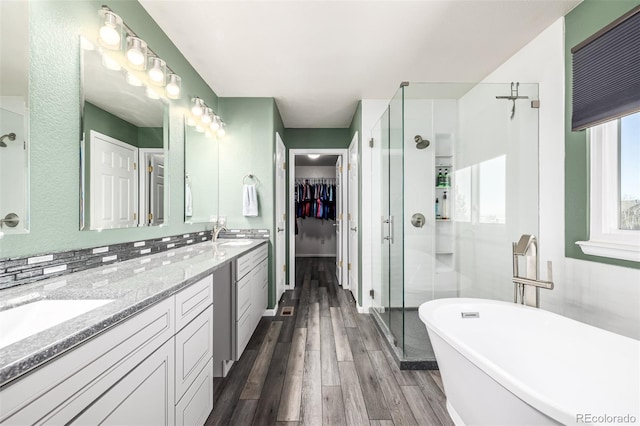 291 Las Lomas St, Brighton, CO 80601 - full bath with a shower stall, double vanity, a freestanding bath, wood finished floors, and a walk in closet
