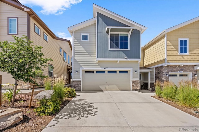 4177 E 98th Pl, Thornton, CO 80229 - view of front facade with stone siding, a garage, and driveway