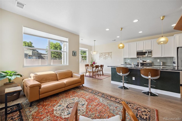 4177 E 98th Pl, Thornton, CO 80229 - living room featuring light wood-style floors and recessed lighting