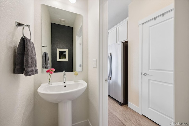 4177 E 98th Pl, Thornton, CO 80229 - bathroom featuring wood finished floors and baseboards
