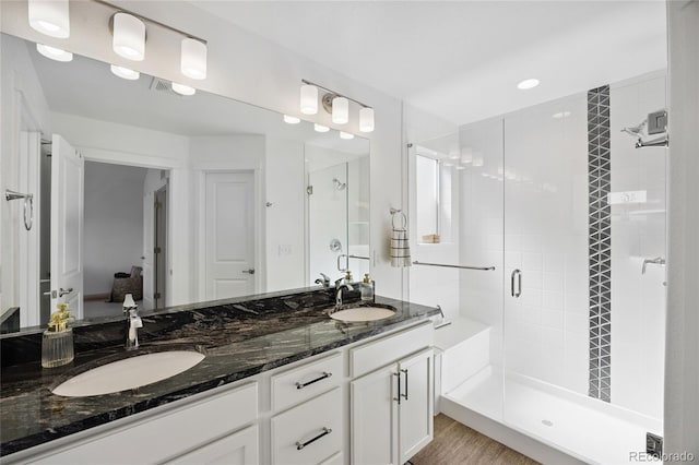 4177 E 98th Pl, Thornton, CO 80229 - bathroom with a stall shower, double vanity, and wood finished floors