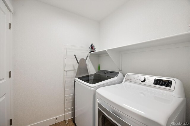 4177 E 98th Pl, Thornton, CO 80229 - washroom with washing machine and clothes dryer and baseboards