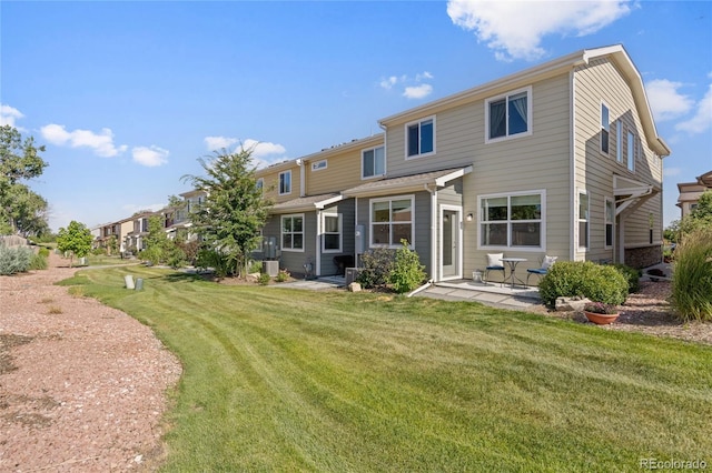 4177 E 98th Pl, Thornton, CO 80229 - back of property featuring a patio area and a lawn