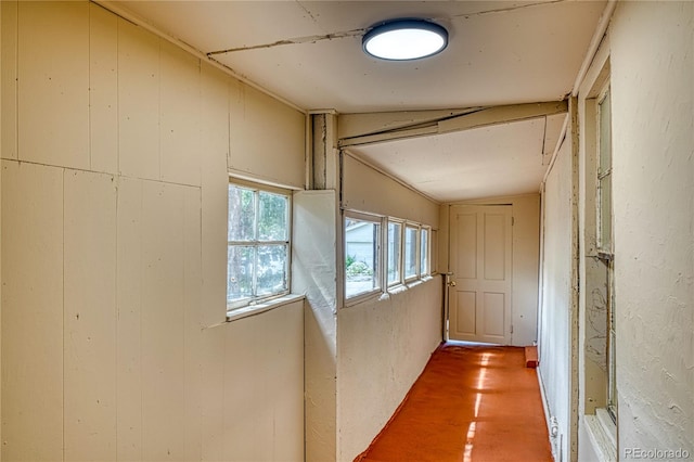 hall featuring lofted ceiling