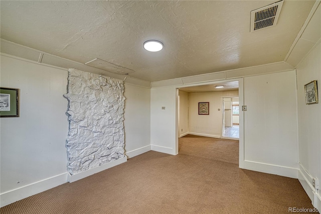 carpeted spare room with a textured ceiling