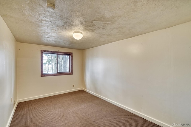 unfurnished room featuring carpet floors and a textured ceiling