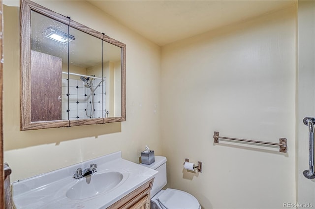 bathroom featuring vanity, toilet, and walk in shower