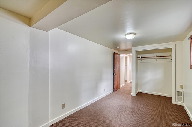 unfurnished bedroom featuring a closet and carpet