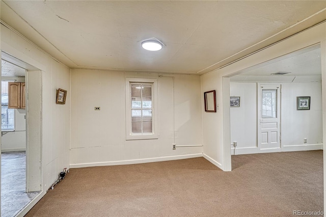 unfurnished room featuring a healthy amount of sunlight and carpet flooring