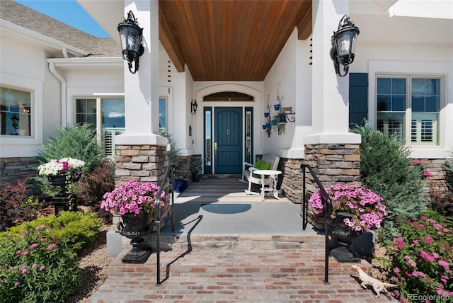 view of exterior entry with covered porch