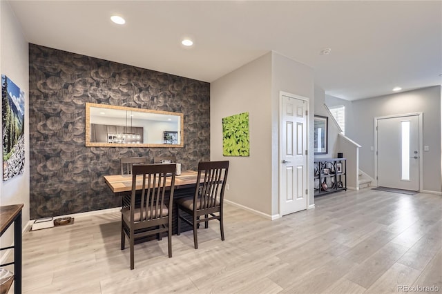 dining space with light hardwood / wood-style floors