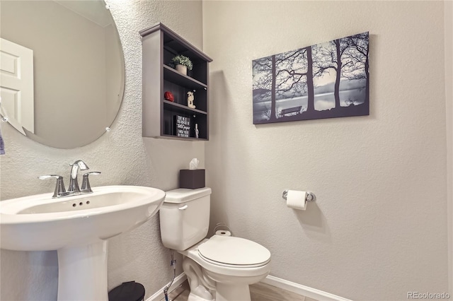 bathroom featuring toilet and sink