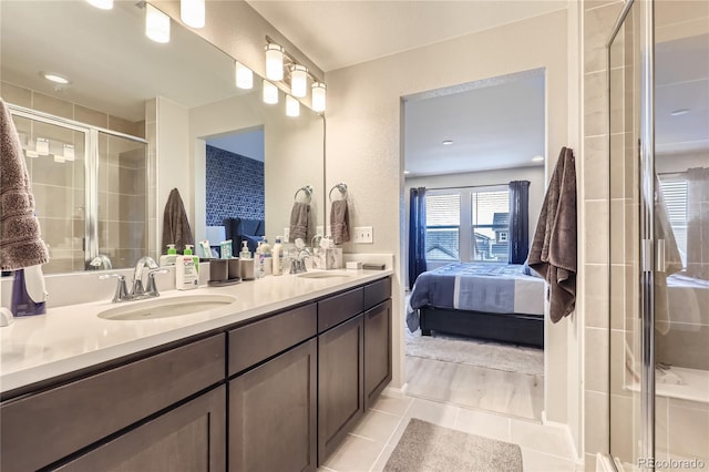 bathroom featuring tile patterned flooring, vanity, and a shower with shower door