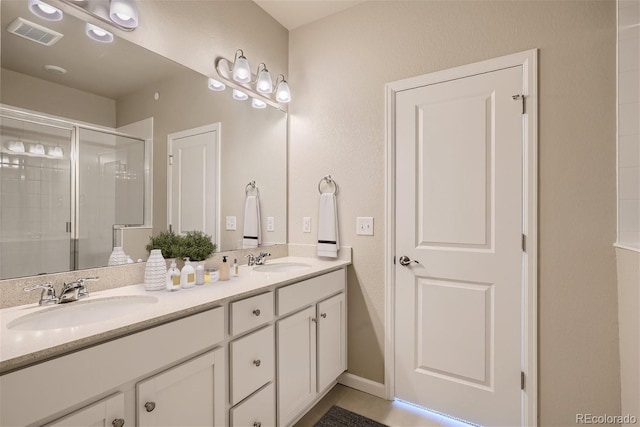 bathroom with an enclosed shower and vanity