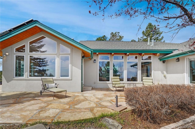 25803 Aspen Way, Golden, CO 80401 - back of property featuring a patio area, stucco siding, and roof with shingles