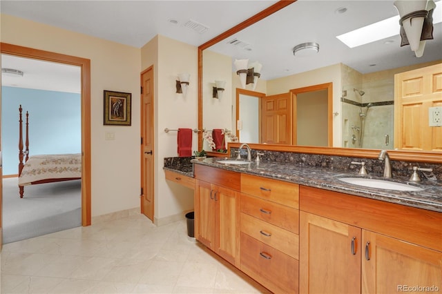 25803 Aspen Way, Golden, CO 80401 - ensuite bathroom with a shower stall, double vanity, a skylight, and baseboards