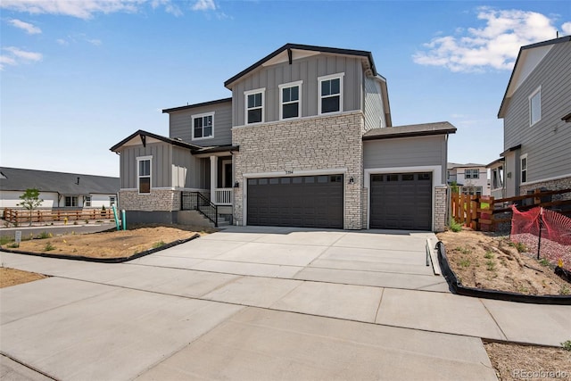 3394 N Grand Baker Ct, Aurora, CO 80019 - view of front of home with board and batten siding, stone siding, and an attached garage