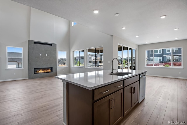 3394 N Grand Baker Ct, Aurora, CO 80019 - kitchen with open floor plan, light wood-style flooring, healthy amount of natural light, recessed lighting, and a high ceiling