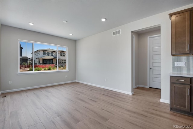 3394 N Grand Baker Ct, Aurora, CO 80019 - unfurnished living room with light wood-style floors and recessed lighting