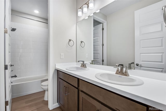3394 N Grand Baker Ct, Aurora, CO 80019 - bathroom featuring wood finished floors, double vanity, and shower / bath combination