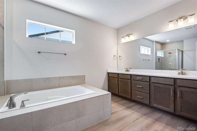 3394 N Grand Baker Ct, Aurora, CO 80019 - full bathroom with a stall shower, double vanity, a bath, and wood finished floors
