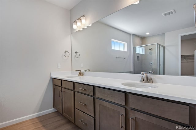 3394 N Grand Baker Ct, Aurora, CO 80019 - full bathroom featuring a shower stall, double vanity, wood finished floors, and a walk in closet