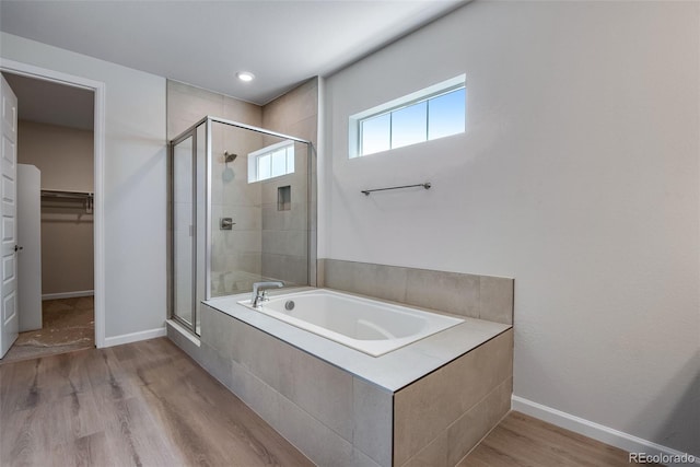 3394 N Grand Baker Ct, Aurora, CO 80019 - bathroom featuring a shower stall, a bath, wood finished floors, and a spacious closet