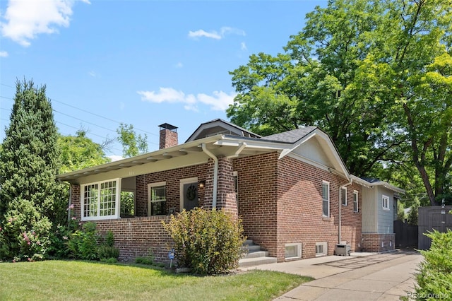 864 Garfield St, Denver, CO 80206 - view of home's exterior featuring brick siding and a chimney