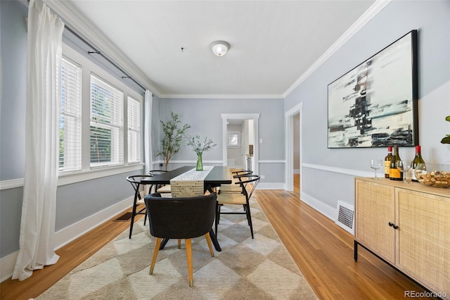 864 Garfield St, Denver, CO 80206 - dining area with light wood finished floors and crown molding