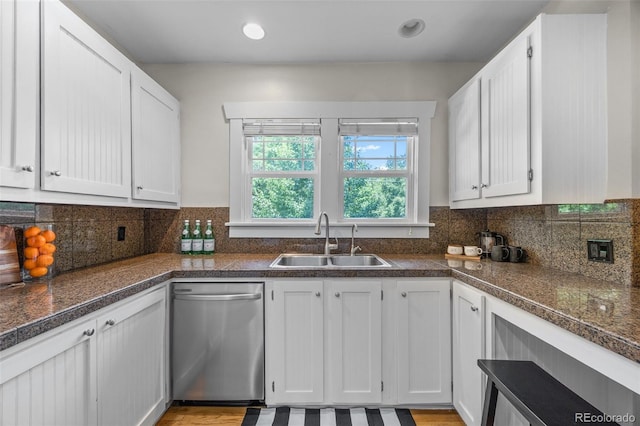 864 Garfield St, Denver, CO 80206 - kitchen with stainless steel dishwasher, white cabinets, and backsplash