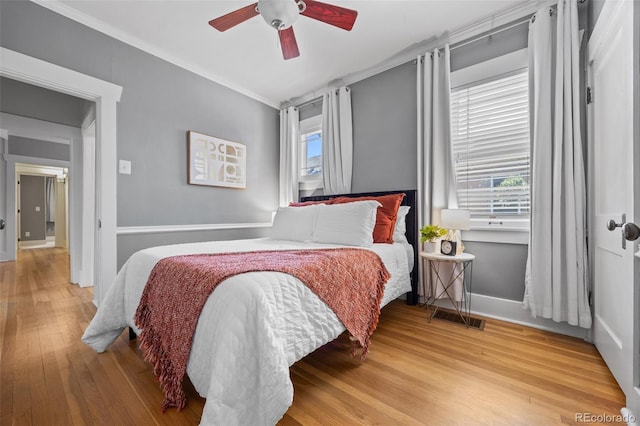864 Garfield St, Denver, CO 80206 - bedroom featuring multiple windows, wood finished floors, ornamental molding, and a ceiling fan