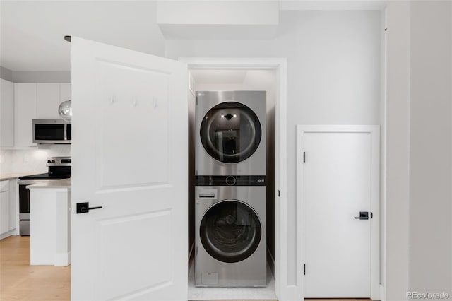 4232 Jason St Unit 2, Denver, CO 80211 - laundry area with estacked washer and dryer and light wood finished floors