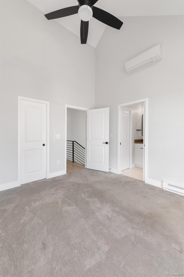 4232 Jason St Unit 2, Denver, CO 80211 - unfurnished bedroom featuring high vaulted ceiling, a wall mounted air conditioner, carpet, baseboard heating, and connected bathroom