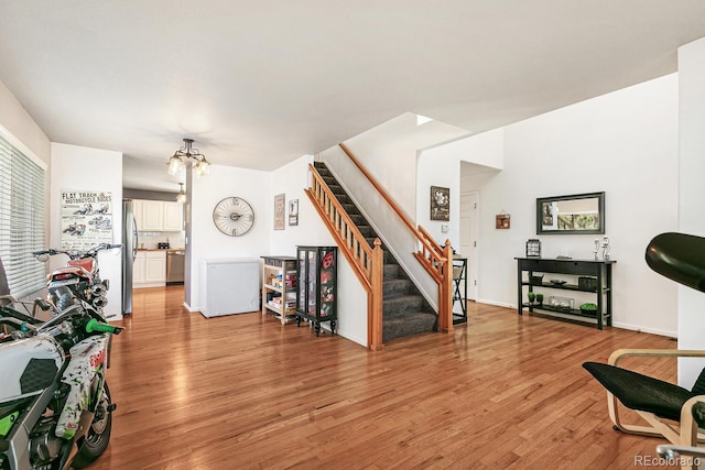 living room featuring light hardwood / wood-style flooring and an inviting chandelier