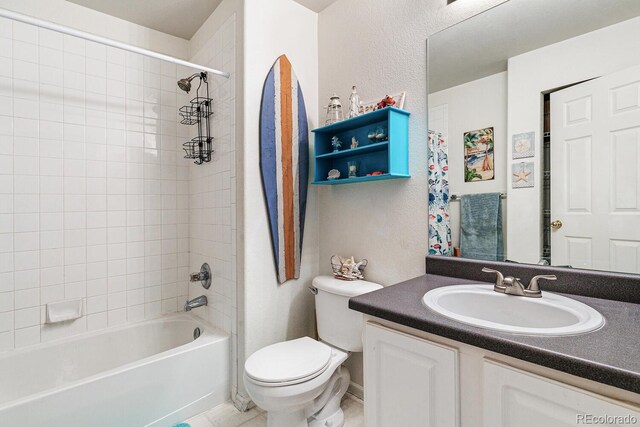 full bathroom featuring toilet, vanity, and tiled shower / bath