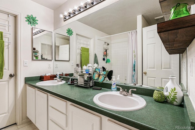 bathroom with a shower with curtain, tile patterned flooring, and vanity