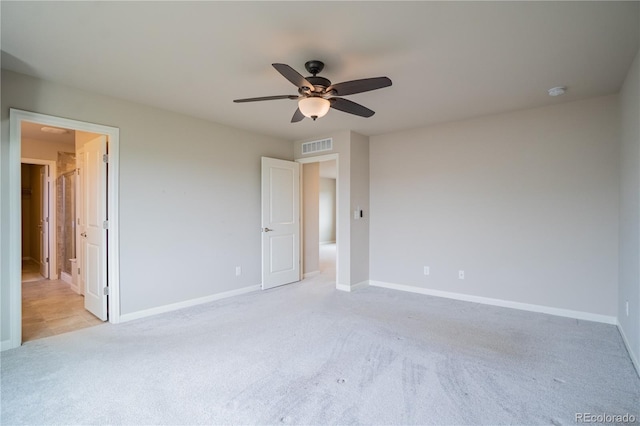 unfurnished bedroom with visible vents, baseboards, ceiling fan, and light carpet