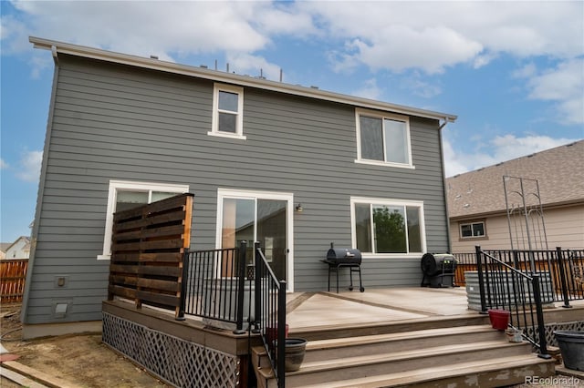 back of property with a wooden deck