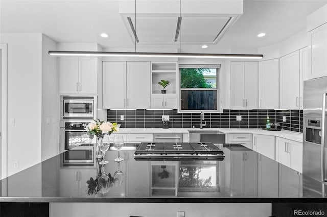2745 Java Ct, Denver, CO 80211 - kitchen featuring stainless steel appliances, a center island, white cabinetry, tasteful backsplash, and recessed lighting