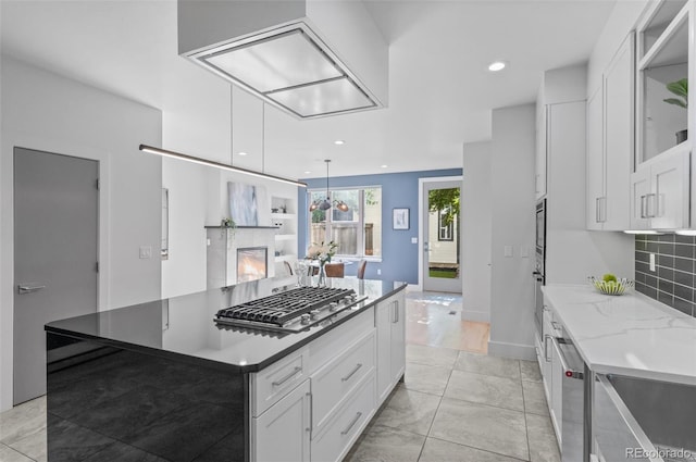 2745 Java Ct, Denver, CO 80211 - kitchen featuring stainless steel appliances, white cabinetry, tasteful backsplash, recessed lighting, and light stone countertops