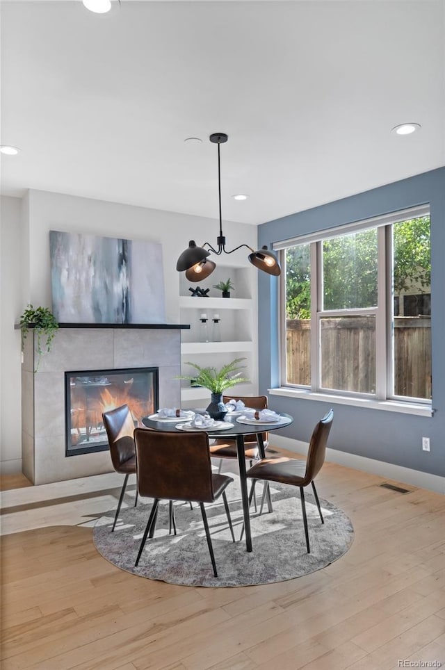 2745 Java Ct, Denver, CO 80211 - dining space featuring a fireplace, wood finished floors, recessed lighting, and built in features