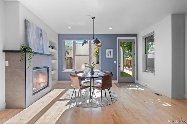 2745 Java Ct, Denver, CO 80211 - dining area with wood-type flooring, a tiled fireplace, and recessed lighting