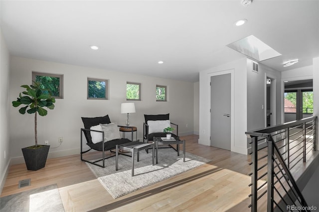 2745 Java Ct, Denver, CO 80211 - living area with wood finished floors, healthy amount of natural light, a skylight, and recessed lighting