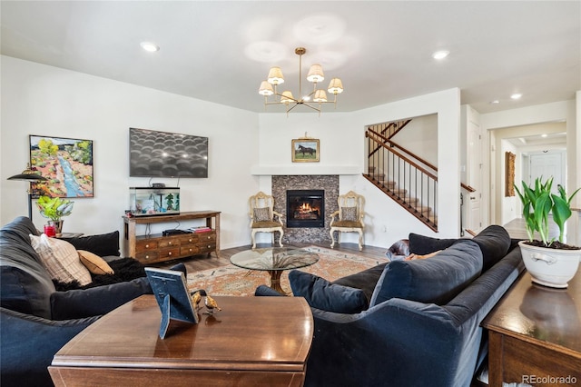 14938 Vienna Cir, Parker, CO 80134 - living area featuring stairs, wood finished floors, a chandelier, a tile fireplace, and recessed lighting
