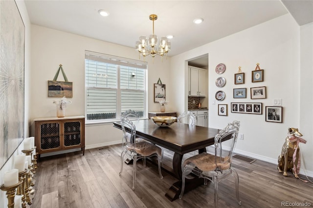 14938 Vienna Cir, Parker, CO 80134 - dining room featuring a chandelier, dark wood-style flooring, baseboards, and recessed lighting