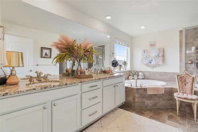 14938 Vienna Cir, Parker, CO 80134 - bathroom with a garden tub, double vanity, a shower stall, and recessed lighting