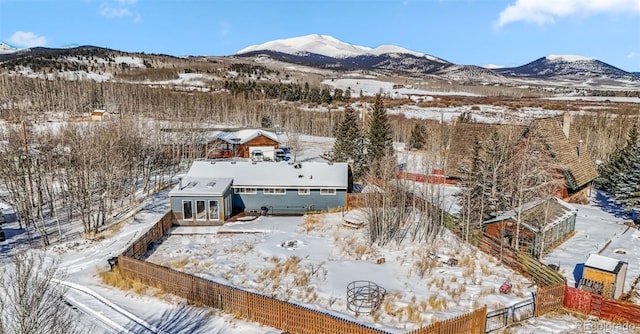 snowy aerial view featuring a mountain view